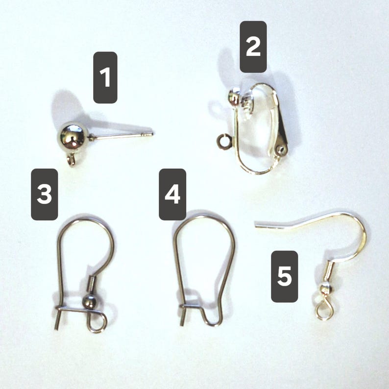 May include: Five silver-toned earring findings labeled 1 through 5. Item 1 is a ball post, 2 is a clip-on finding, 3 is a kidney wire, 4 is a leverback, and 5 is a fishhook ear wire. Each component features a small loop for attaching jewelry.