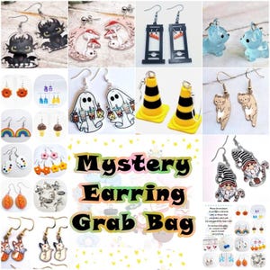 May include: A collection of various earrings, including cartoon characters, food items, and novelty designs. The earrings are displayed in a grid, with a central text that reads "Mystery Earring Grab Bag". The earrings are in various colors and styles.