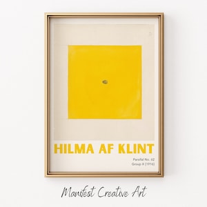 May include: A framed print of a yellow abstract painting by Hilma af Klint, titled "Parsifal No. 62, Group X (1916)". The print is in a gold frame and has a white background.