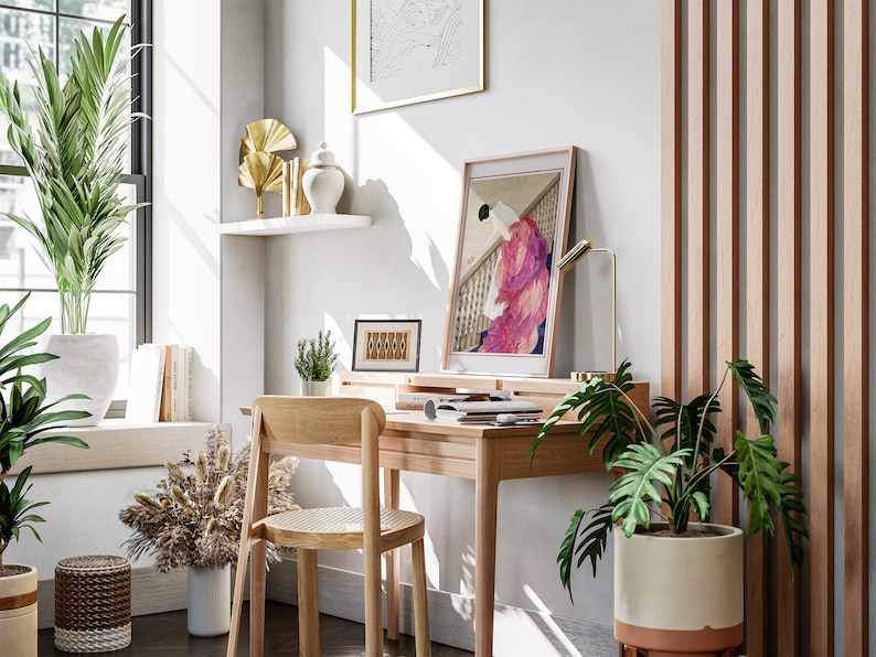 a room with a desk, chair, potted plants and a window