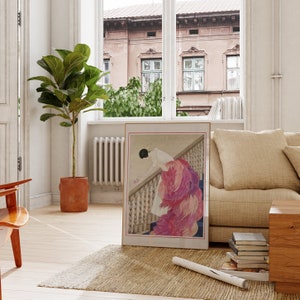 a living room with a picture of a woman on the wall