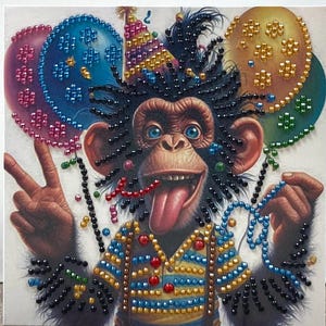 May include: Square artwork featuring a chimpanzee with a party hat, sticking out its tongue, and giving a peace sign. The chimp is wearing a blue and yellow striped shirt and surrounded by beaded balloons. The artwork is embellished with colorful beads.