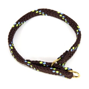 May include: A brown rope dog collar with blue and green accents. The collar has a gold metal D-ring.