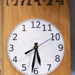 May include: A wooden clock with the name "Chloe" carved into the top. The clock face is white with black numbers and hands.