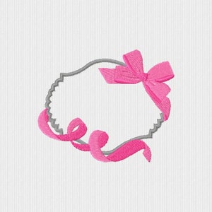 May include: An embroidered design featuring a gray, scalloped-edge frame with a bright pink bow and ribbon accents. The design is set against a white background, creating a delicate and feminine aesthetic.