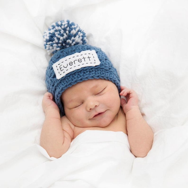 This personalized hat is available in 43 different colors and it comes with a pom pom on top.  This hat should be hand washed and laid flat to dry.  The embroidery on this hat is done with dark gray floss.  This hat is the color blue moon.