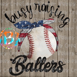 May include: A baseball with red stitching and an American flag-themed bow. The words "busy raising Ballers" are written in a script font. The background is a wood-grain texture.