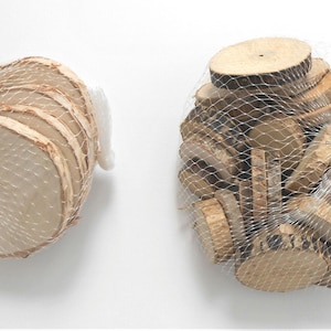 May include: Two bags of wood slices. One bag contains a stack of six round wood slices, while the other bag contains a large quantity of smaller wood slices.