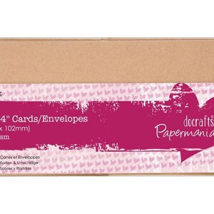 May include: A package of 25 cards and envelopes, each measuring 4 x 4 inches. The packaging is a light brown color with a magenta label that includes the text "docrafts Papermania". The label also indicates the cards are 300gsm.