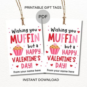May include: Two printable Valentine's Day gift tags with a muffin graphic. The tags read "Wishing you MUFFIN but a HAPPY VALENTINE'S DAY!" in red and pink. Includes space to add a name. The tags are attached to twine.