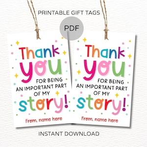 May include: A white ceramic mug with a black handle and the text "But First, Coffee" in a bold, black font. The mug is set against a blurred background, suggesting a cozy setting.