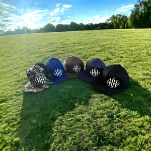 Heavy Hitters USA HH logo Flexfit flat bill hats available in Black, Navy, Royal Blue, Red and Dark Grey