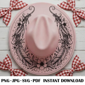 May include: A light pink hat featuring a black line art illustration of two large feathers, flowers, and small stars arranged in a symmetrical pattern around the crown. The text at the bottom reads PNG JPG SVG PDF INSTANT DOWNLOAD.