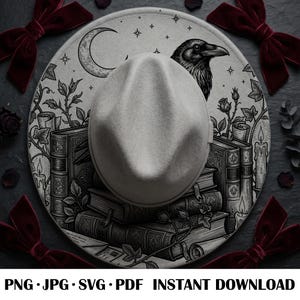 May include: A light gray fedora hat featuring a detailed black ink illustration of a raven, a crescent moon, stars, stacked vintage books, lit candles, and climbing ivy vines. The design covers the brim and crown of the hat in a dark aesthetic.