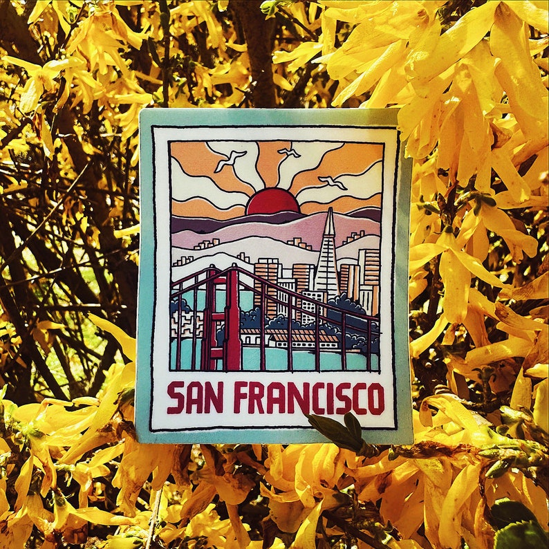 May include: A colorful illustration of the San Francisco skyline with the Golden Gate Bridge and the city's iconic buildings. The illustration is on a blue background with a yellow border and the text "San Francisco" at the bottom.
