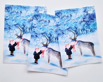 May include: A watercolor illustration of a girl hugging a reindeer in a snowy forest. The text "A hug is the perfect gift. One size fits all." is written in white on a blue background.