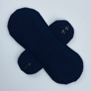 May include: A dark blue reusable cloth pad with snaps on the sides.