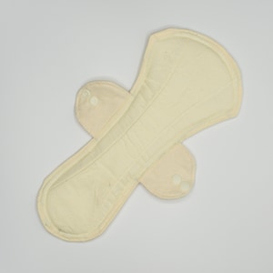 May include: A beige reusable cloth menstrual pad with two white snap buttons on each side.