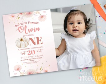 May include: A baby girl in a white dress and a first birthday invitation. The invitation has a pink background with floral accents and the text "Our Little Pumpkin Olivia is turning ONE". The invitation also includes event details.