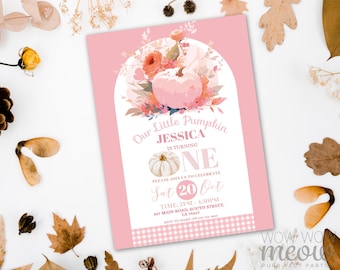 May include: Pink invitation card with the text "Our Little Pumpkin Jessica is turning ONE". The card features a pumpkin and floral design. The invitation includes the date, time, and location for the event.