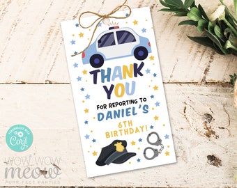 May include: Blue and white police car thank you tag with gold stars, a police hat, and handcuffs. The text reads "Thank You for reporting to Daniel's 6th Birthday!"