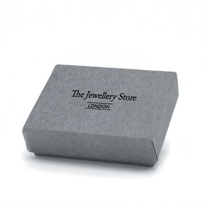 May include: A gray cardboard box with the text "The Jewellery Store LONDON" printed on the top.