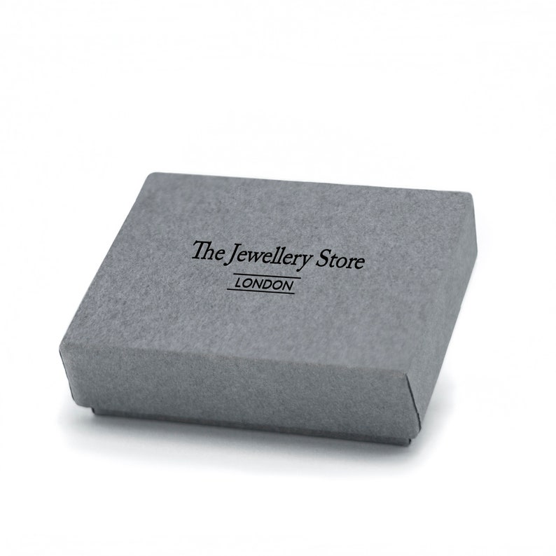 May include: A gray cardboard box with the text "The Jewellery Store LONDON" printed on the top.