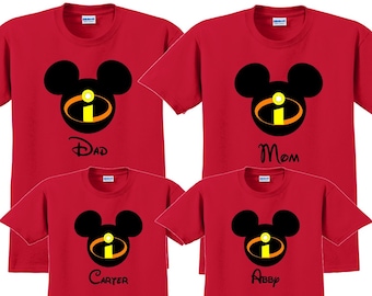 May include: Red t-shirts with a black Mickey Mouse head with a yellow and red 'I' inside. The shirts say 'Dad', 'Mom', 'Carter', and 'Abby'.