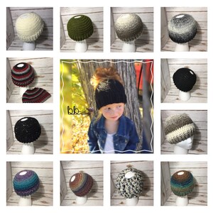 May include: A collection of 12 crocheted hats in various colors and patterns, including black, white, green, brown, blue, and grey. Some hats have a messy bun space in the back.