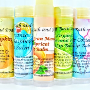 May include: Six different flavored lip balms in tubes with colorful labels. The flavors are: Cherry Pumpkin, Organic Raspberry, Gran Marnier Apricot, Organic Coconut Lime, Organic Cotton Candy, and Organic Birthday Cake.