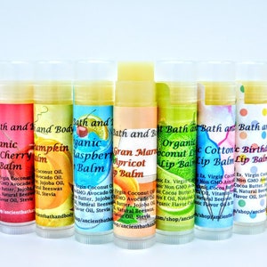 May include: A row of 10 colorful lip balms with various flavors, including cherry, pumpkin, raspberry, apricot, coconut lime, cotton candy, birthday cake, and strawberry. Each balm is labeled with the name of the flavor and the words "Bath and Body" and "Organic Lip Balm".
