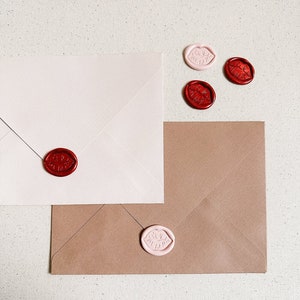 Wax seals in the shape of lips on an envelope. Colours pictured are crimson and ballet.