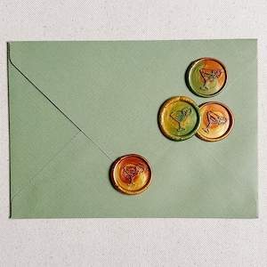 May include: Four green, orange, and yellow wax seals with a cocktail glass design on a green envelope.