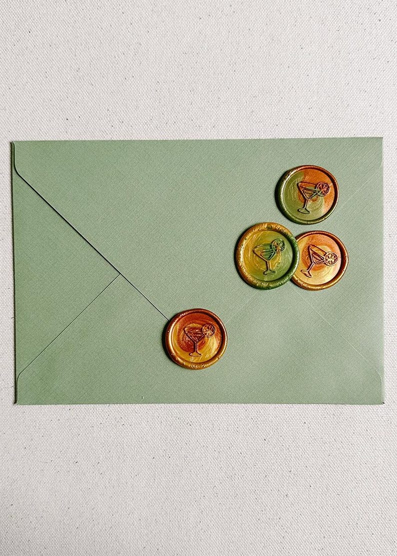 May include: Four green, orange, and yellow wax seals with a cocktail glass design on a green envelope.