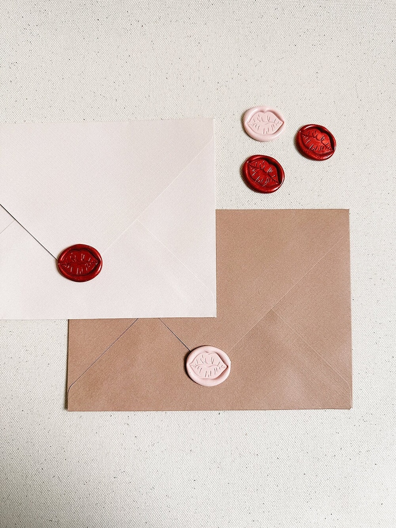 Wax seals in the shape of lips on an envelope. Colours pictured are crimson and ballet.