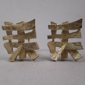 NAPIER Dynasty Collection Clip Earrings.  Chinese Characters in Textured Gold Finish.  Deep Sculptural Angular Shape. Eugene Bertolli Design