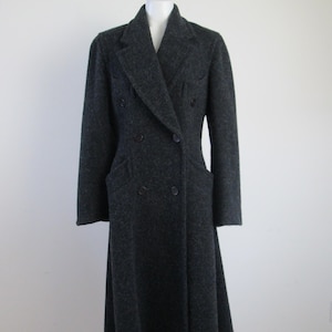May include: A long, dark gray wool coat with a double-breasted closure and a slightly flared skirt.
