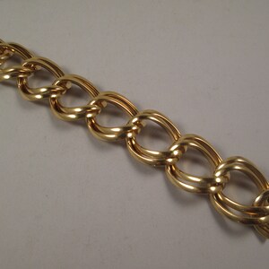 May include: A gold-toned chain link bracelet with a clasp closure.