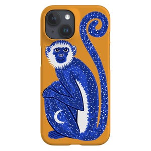 May include: A blue and white monkey phone case with a yellow background. The monkey is sitting down with its tail curled up behind it. The monkey has a white face and a crescent moon on its belly.