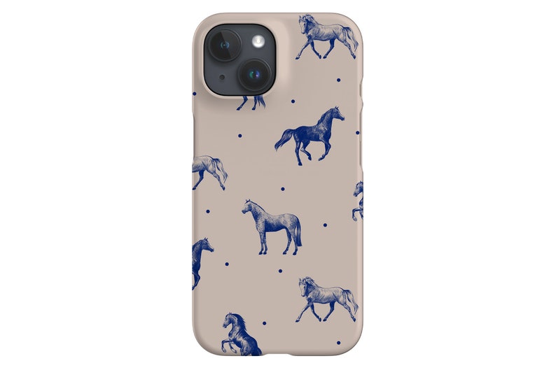 May include: A beige iPhone case with a repeating pattern of blue horses and white dots.