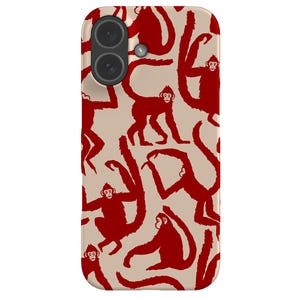 May include: A phone case featuring a repeating pattern of red monkeys on a beige background. The monkeys are in various poses, with long arms and tails. The case has a dual-lens camera cutout.