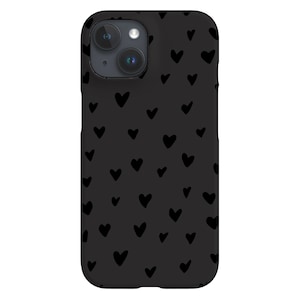 Puede incluir: Funda de teléfono negra con un patrón de pequeños corazones negros sobre un fondo gris oscuro.