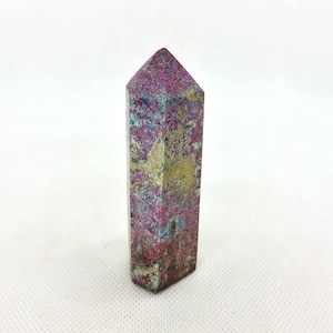 May include: A purple, blue, and gold gemstone point. The point is polished and has a smooth, shiny surface.