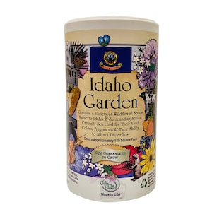 May include: A white cylindrical container with a colorful illustration of wildflowers and the text "Idaho Garden". The container contains wildflower seeds native to Idaho and surrounding states. The text also states that the seeds are guaranteed to grow and cover approximately 100 square feet.