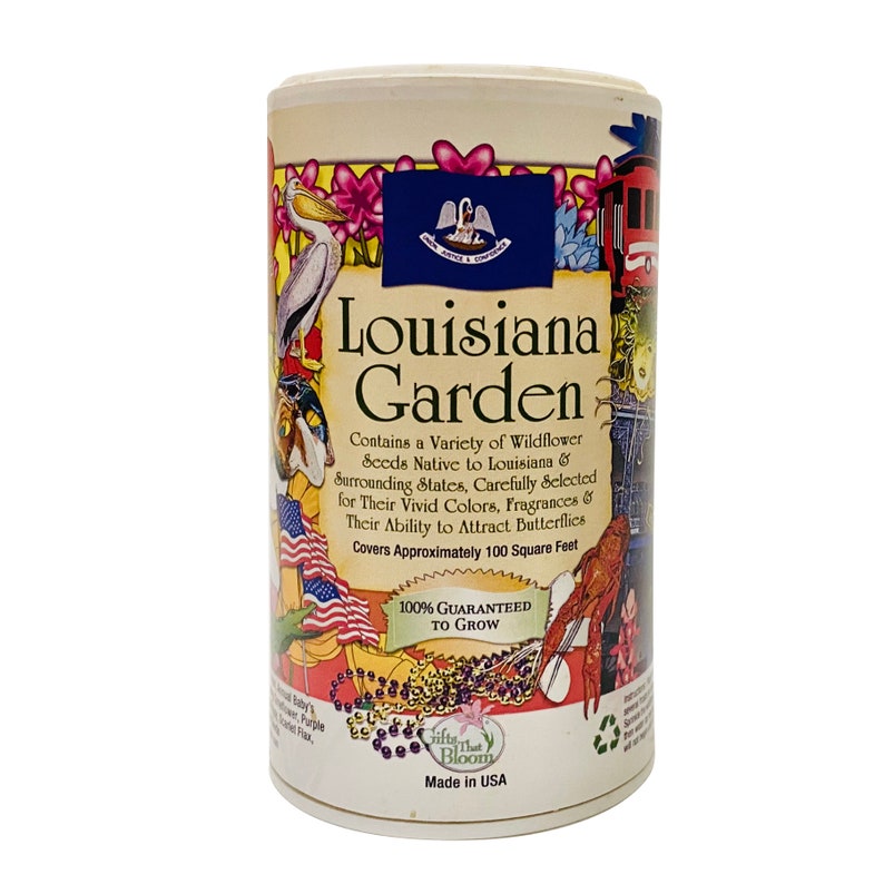 May include: A cylindrical container of wildflower seeds with a colorful illustration of Louisiana landmarks and wildlife. The label reads "Louisiana Garden" and includes the text "Contains a Variety of Wildflower Seeds Native to Louisiana & Surrounding States, Carefully Selected for Their Vivid Colors, Fragrances & Their Ability to Attract Butterflies. Covers Approximately 100 Square Feet. 100% Guaranteed to Grow. Made in USA."