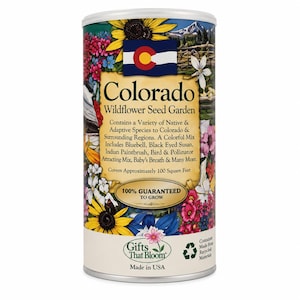 May include: A cylindrical container of Colorado Wildflower Seed Garden featuring a colorful floral design, the Colorado state flag, and text detailing a mix of native species including bluebell, black eyed susan, and indian paintbrush.