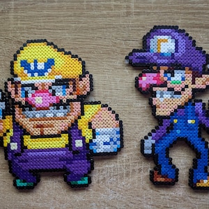 May include: Two pixel art figures made of colorful beads. The figure on the left is a yellow and purple character with a yellow hat and a mustache. The figure on the right is a purple character with a purple hat and a mustache.
