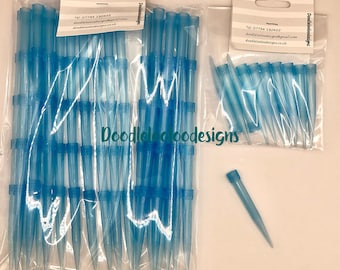 May include: Multiple packs of blue pipette tips are shown, some in clear plastic bags. One tip is separate. The packages have a white tag with contact details and the name "Doodleloo designs".