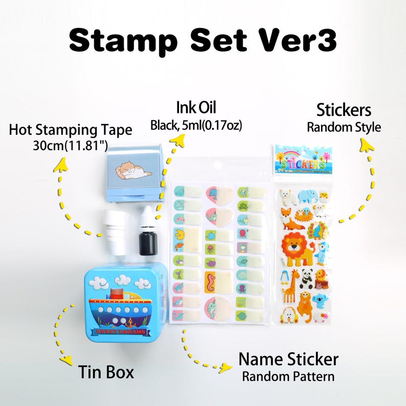May include: A blue tin box with a ship design contains a set of craft supplies. The set includes a hot stamping tape, a small bottle of black ink, and two sheets of stickers. The stickers feature a variety of animal designs and a name sticker with a random pattern.
