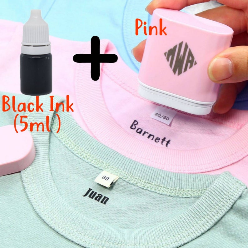 May include: A pink fabric stamper with a black ink bottle. The stamper is being used to stamp the name "Barnett" on a pink shirt. The ink bottle is labeled "Black Ink (5ml)".